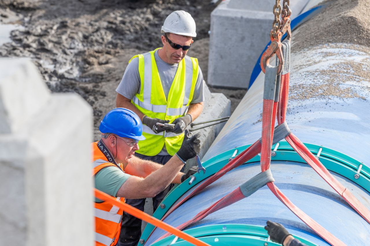 Workers securing a large-diameter pipe connection during the Ballymore Eustace repair